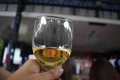 Close-up of person holding drink in glass