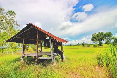 Built structure on field against sky