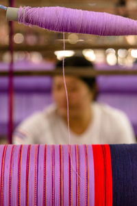 Close-up of woman working of clothing machine
