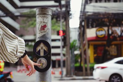 Midsection of man standing on street in city