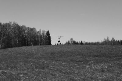 Man on field against clear sky