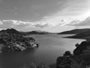 Scenic view of sea and mountains against sky