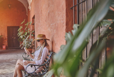 Young tourist checking phone in the santa catalina monastery,  exploring unesco world heritage