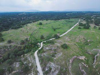 High angle view of road amidst trees against sky