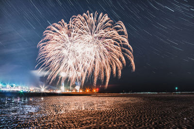 Firework display over beach at night