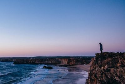 Scenic view of sea against clear sky during sunset