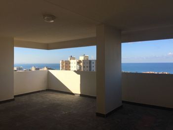 View of sea against sky seen through window