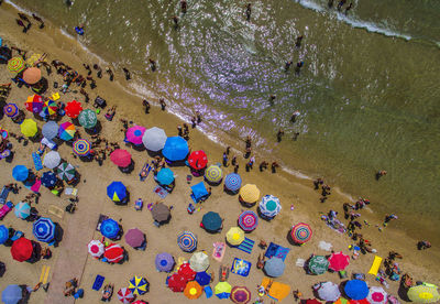 High angle view of people and colorful umbrellas at beach