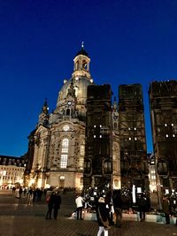 Low angle view of illuminated cathedral against blue sky