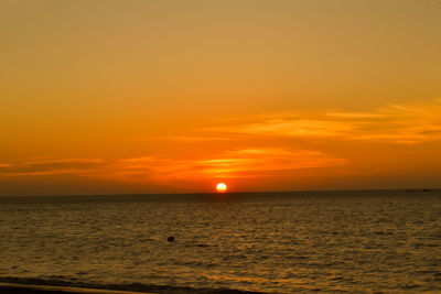 Scenic view of sea against romantic sky at sunset