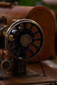 Close-up of old machine part on table