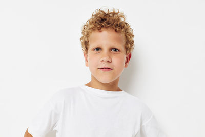 Portrait of smiling boy against white background