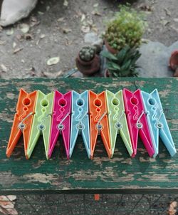 High angle view of colorful clothespins arranged on wood