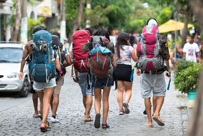 Rear view of people walking on street