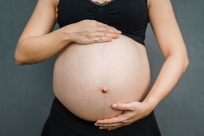 Midsection of woman touching hair