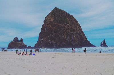 People on beach against sky