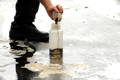 Person is taking a sample to measure the water quality