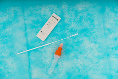 High angle view of warning sign on blue table