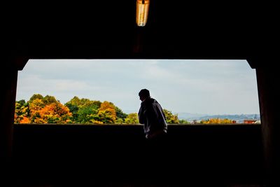 Man standing by railing