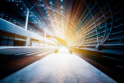 Illuminated tunnel at night