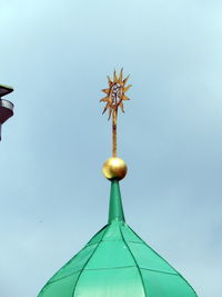 Low angle view of cross against blue sky