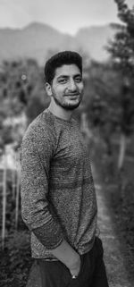 Young man standing against trees. shayan dar