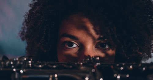 Portrait of young woman playing guitar