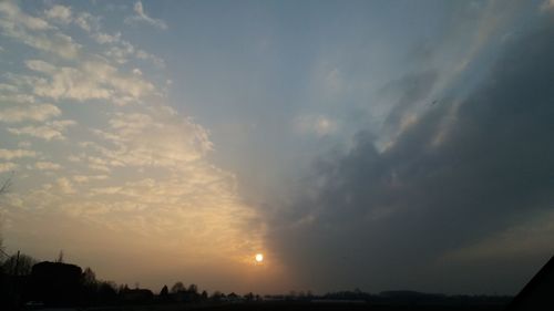 Silhouette landscape against sky during sunset