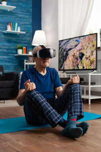 Man sitting on sofa at home