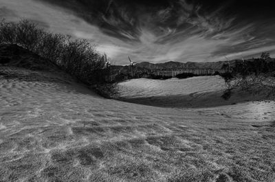 Scenic view of landscape against cloudy sky