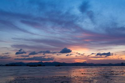 Scenic view of sea against romantic sky at sunset