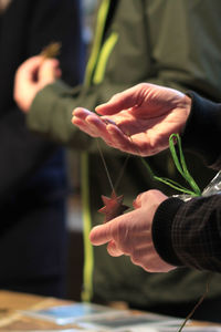 Close-up of hands holding star shape decoration