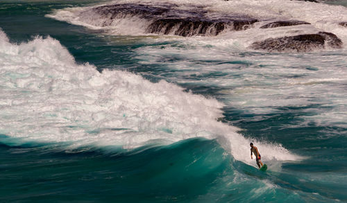 High angle view of man surfing at sea