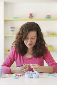 Portrait of smiling woman sitting at table