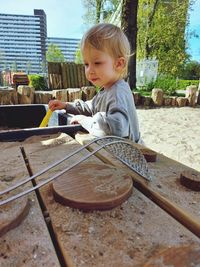 Portrait of toddler playing with sand