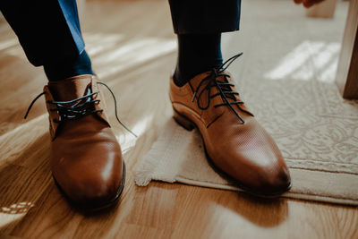 Low section of woman standing on hardwood floor