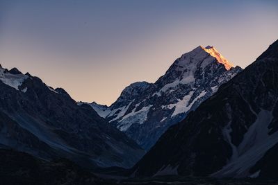 Scenic view of snowcapped mountains against sky during sunset