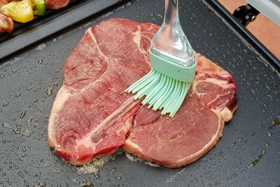 High angle view of meat on barbecue grill