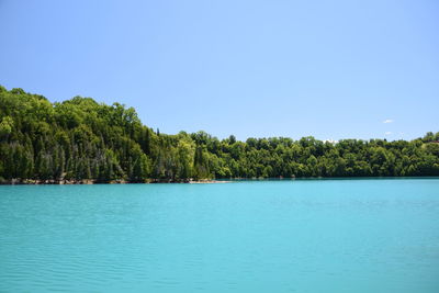 Scenic view of sea against clear blue sky