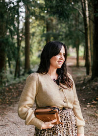 Young woman looking down while standing on land