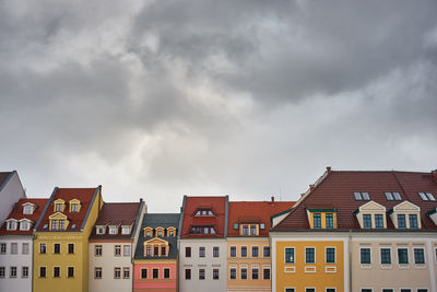 Houses against cloudy sky