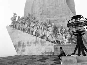 Low angle view of statue against building in city