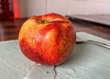 Close-up of wet apple on table