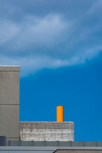 Low angle view of factory against blue sky