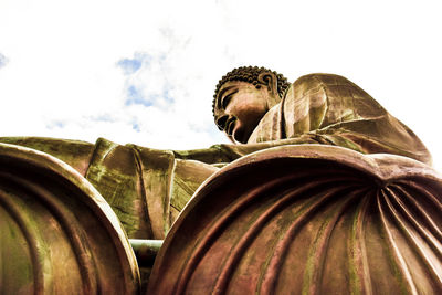 Rear view of man sculpture against sky