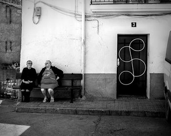 Full length of woman standing in front of building