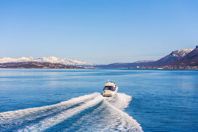 Motor boat heading to tromso in norway