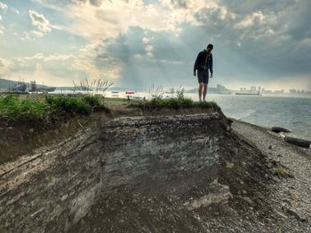 Full length of man walking by sea against sky