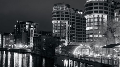 Reflection of illuminated buildings in city at night