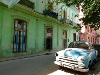 Vehicles on road against buildings in city